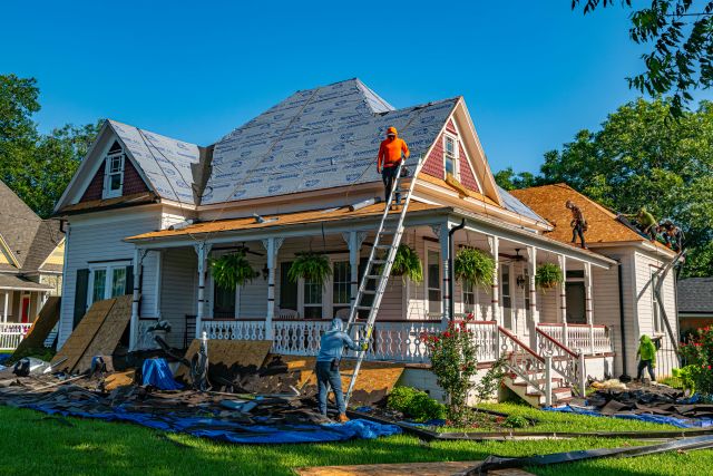 Contractors Repairing a Roof on a House